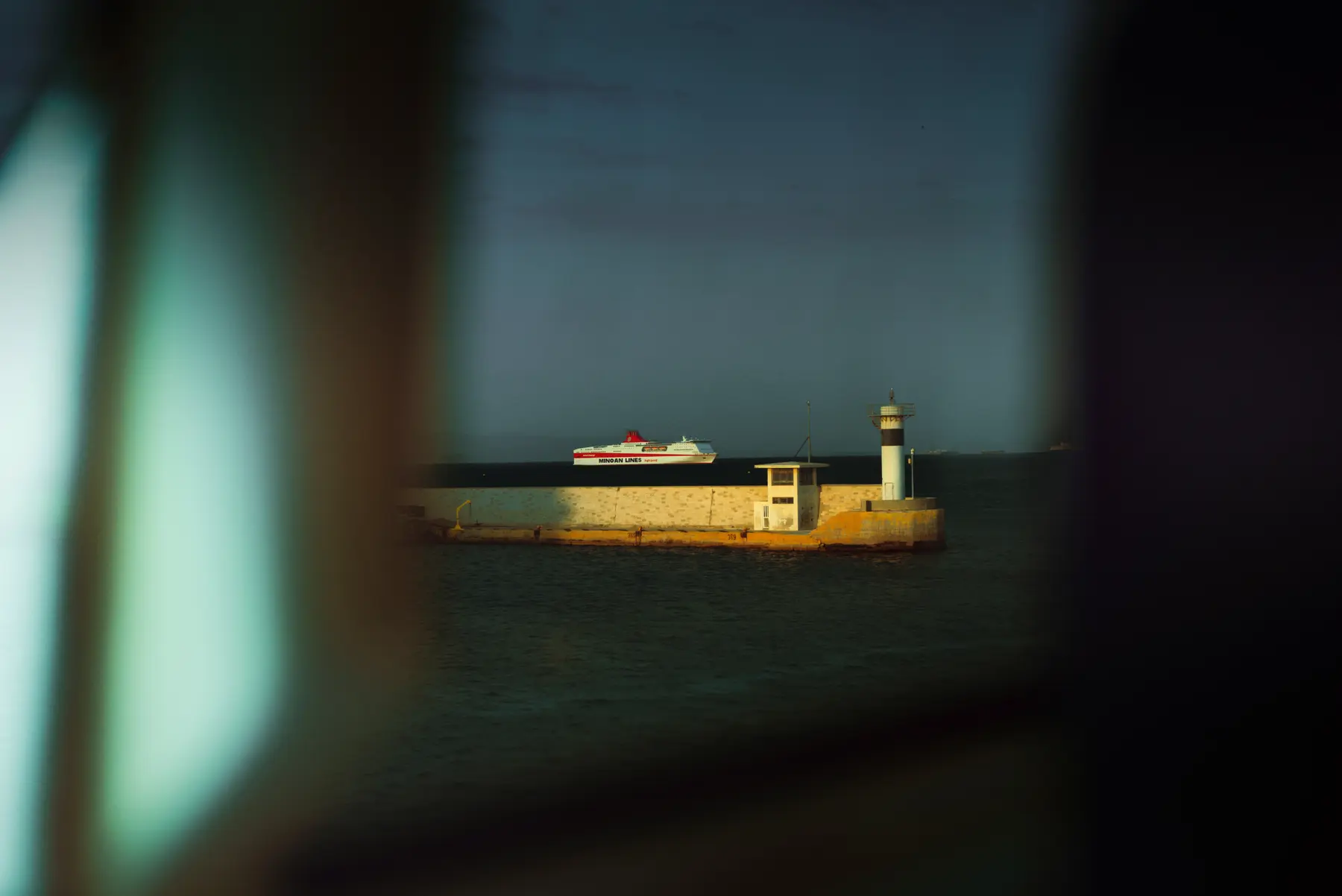 Passenger ferry and lighthouse at Piraeus Harbour