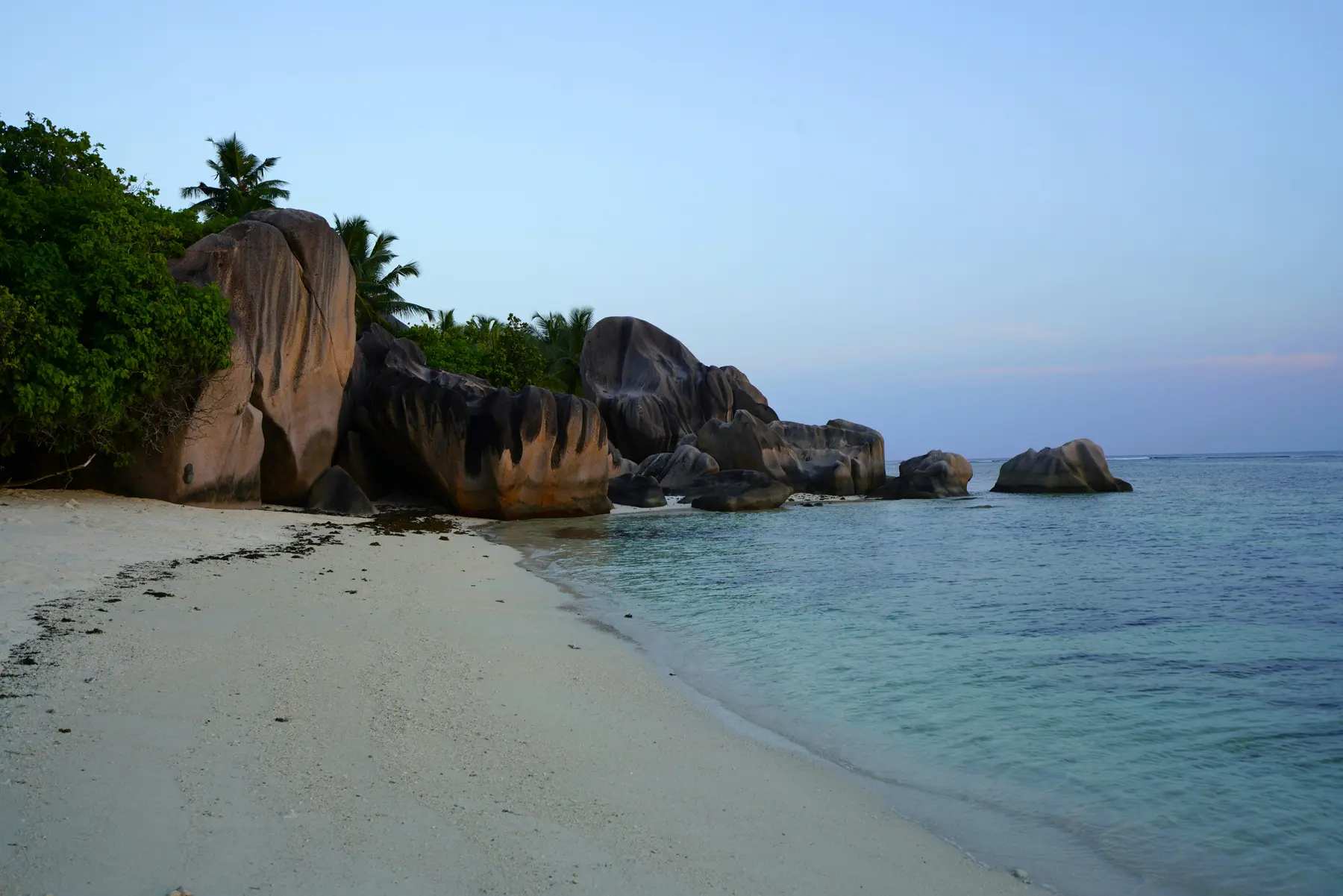 Granite boulders and calm turquoise water on La Digue, Seychelles